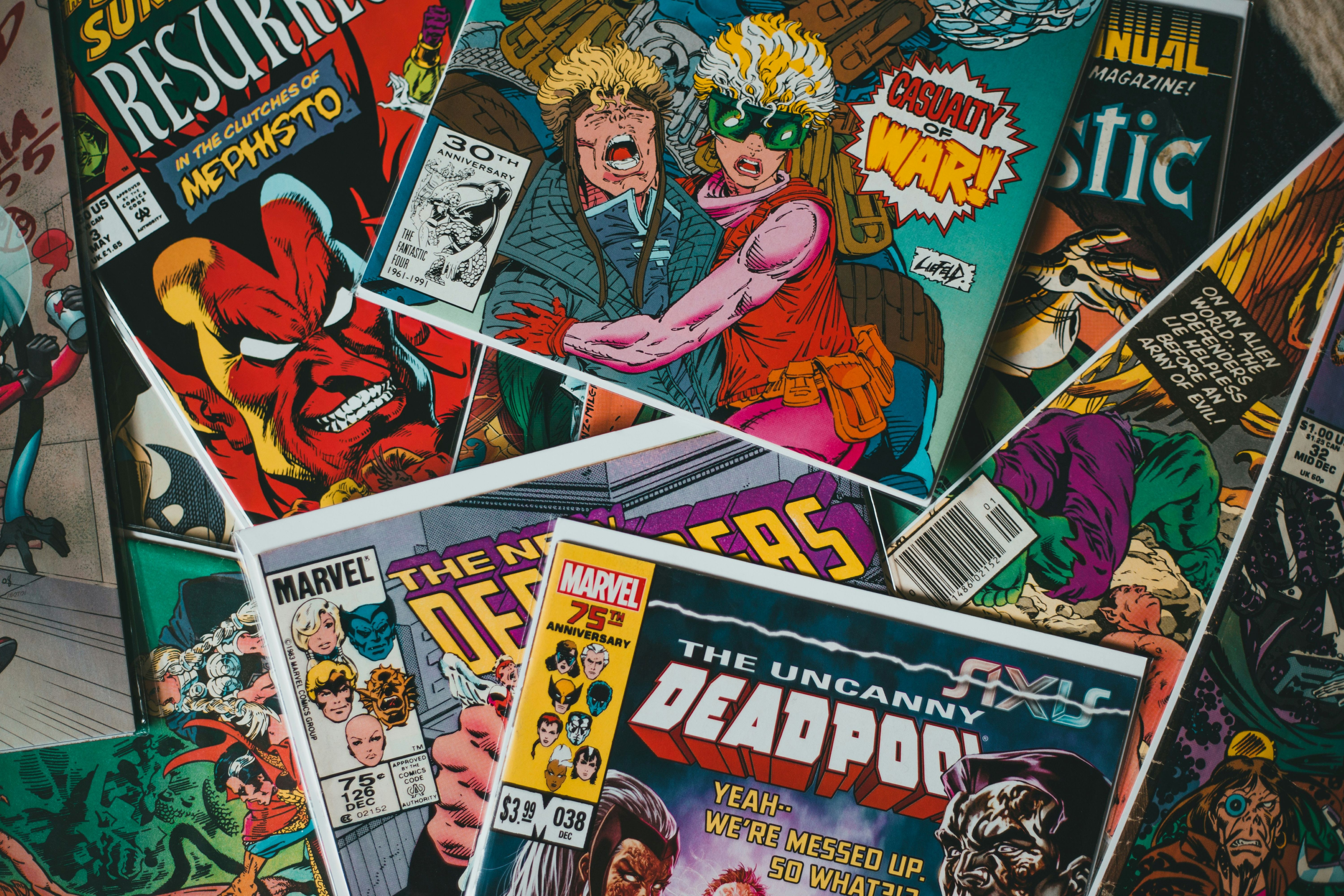 stack of comics with Uncanny Deadpool in the center
